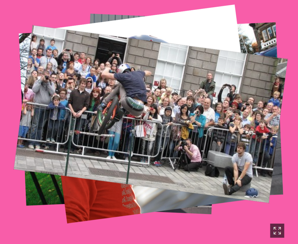 A group of people watching a person skate